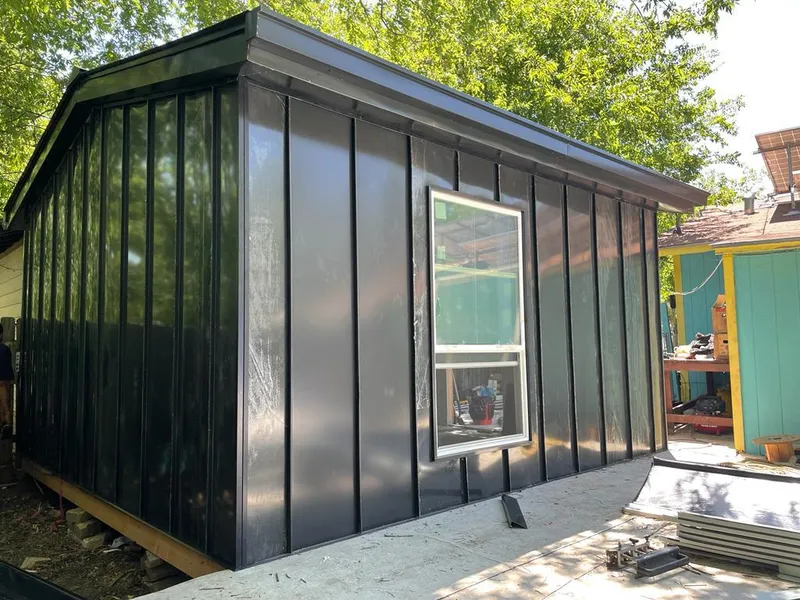 Black standing seam metal wall panels for Roof Inspection in St. Anthony