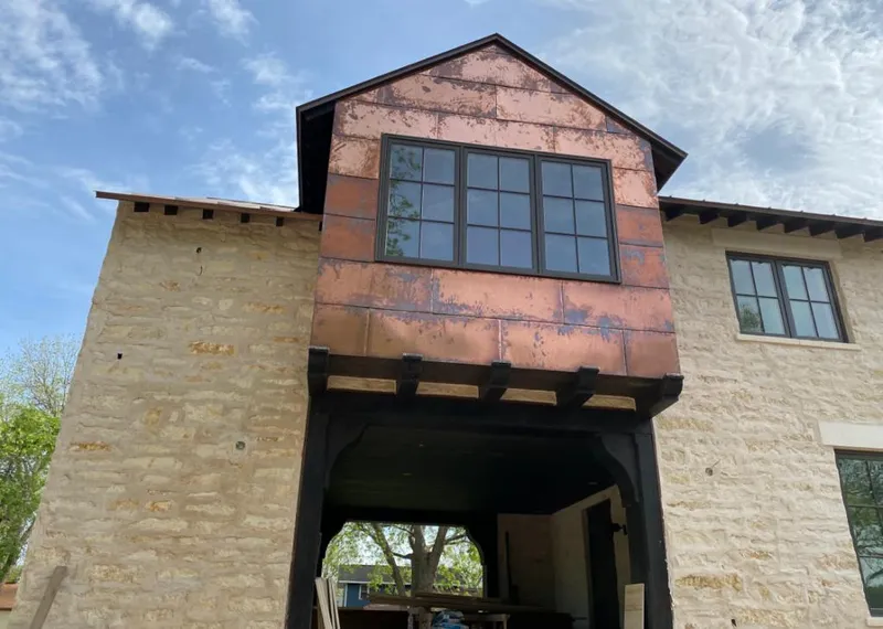 Copper metal panel facade on a stone building for Metal Roof Coating in St. Anthony